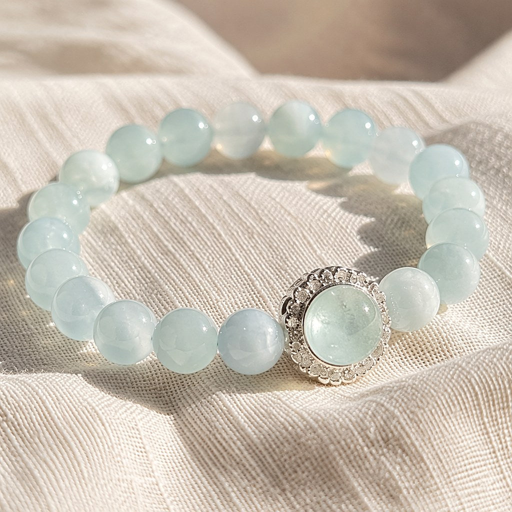 Ocean's Whisper pale blue aquamarine beaded stretch bracelet with silver-tone pave halo charm
