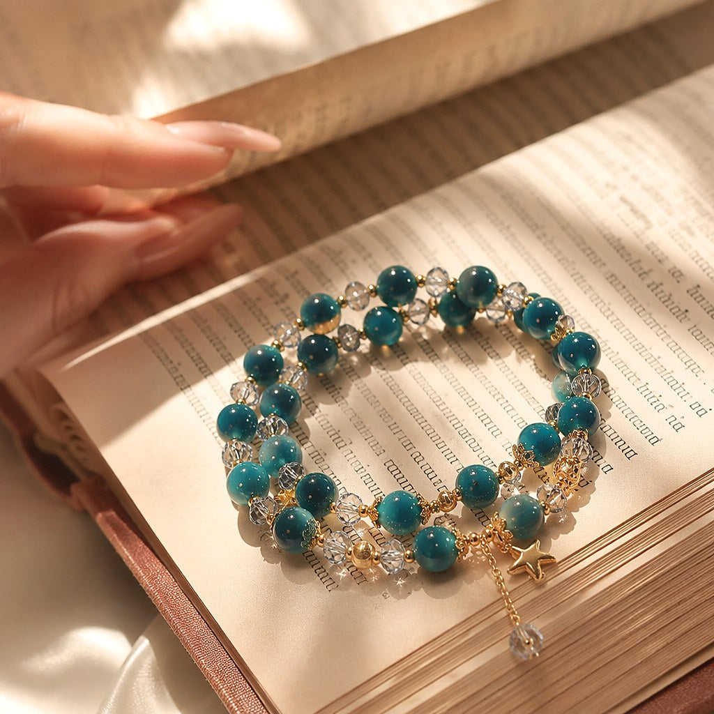 Starlit Azure Wrap double-wrap bracelet with chatoyant deep teal blue tiger's eye beads, faceted clear crystal rondelles