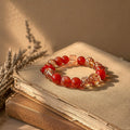 Blazing Sun Agate bracelet with cherry-red agate rounds, gold-foil flecked champagne quartz beads and a faceted strawber