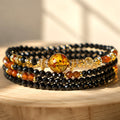 Capricorn zodiac triple-wrap bracelet with faceted black tourmaline beads, flower amber statement bead, citrine accents,