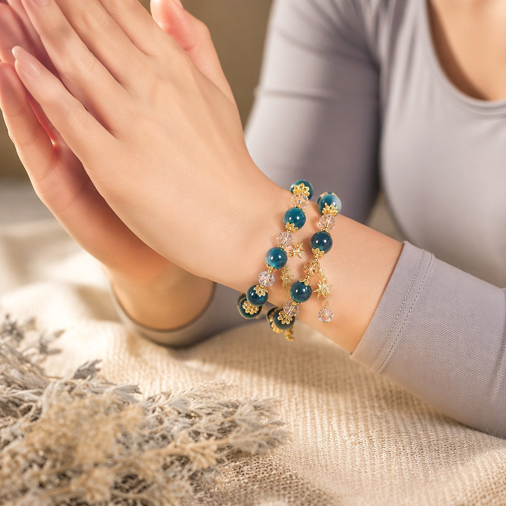 Starlit Azure Wrap double-wrap bracelet with chatoyant deep teal blue tiger's eye beads, faceted clear crystal rondelles