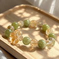 Lemon Bubble citrine, Xiuyan jade and clear quartz beaded stretch bracelet with carved citrine flower bead